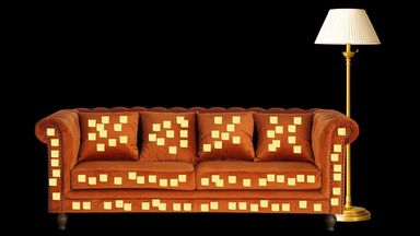 A couch covered in sticky notes.