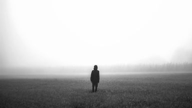 Person in a foggy field