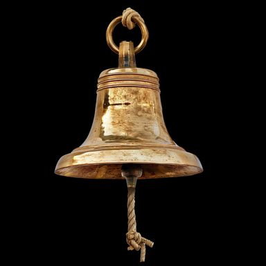 Rustic bronze bell with knotted rope pull at bottom.