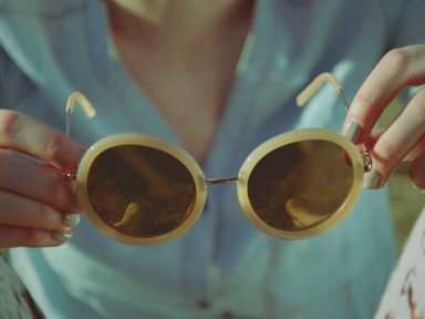 woman holding retro sunglasses
