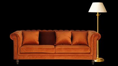 A couch missing a cushion.
